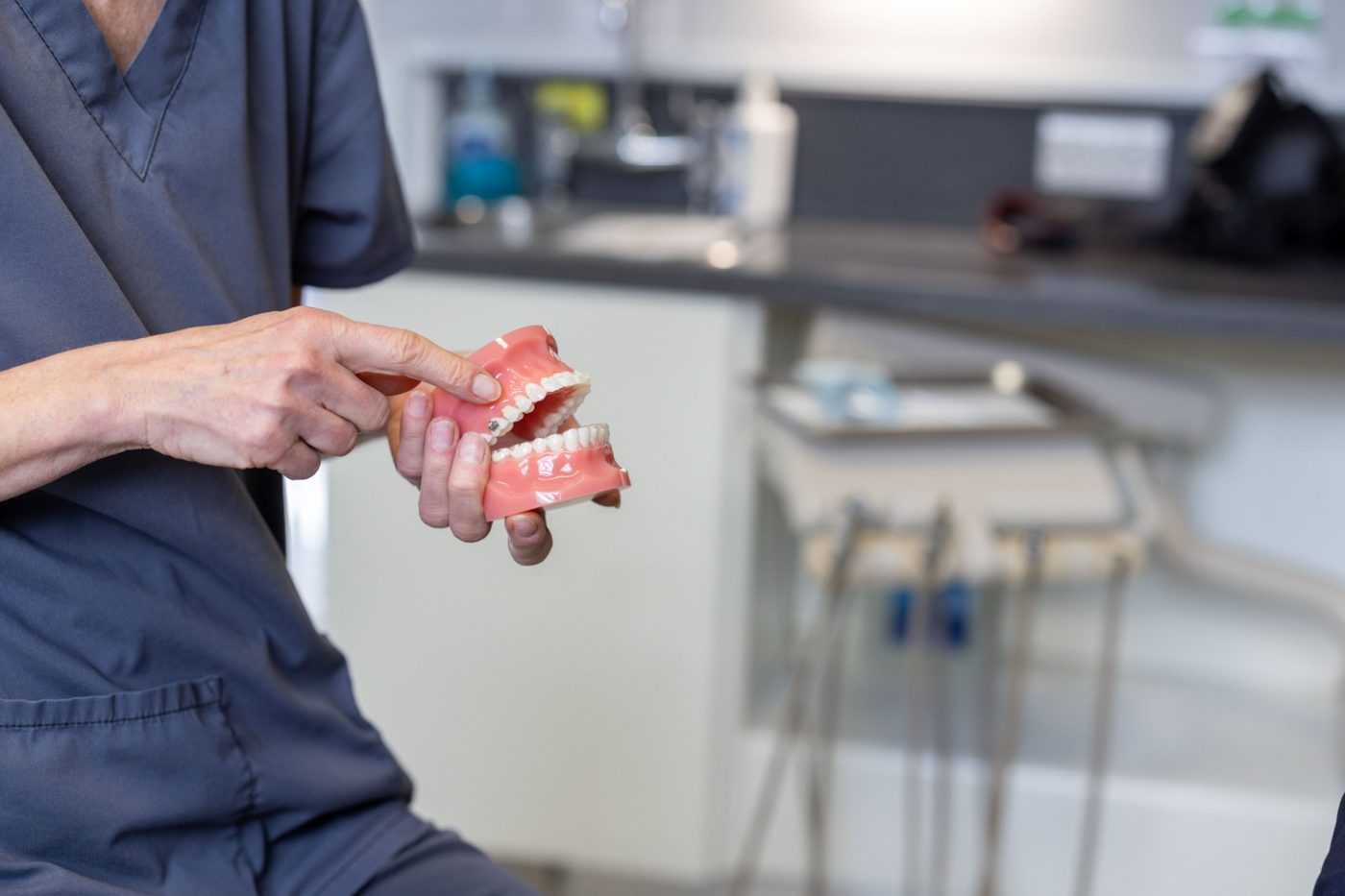 Implant dentist at Shenstone Dental Centre explaining treatment using a dental model